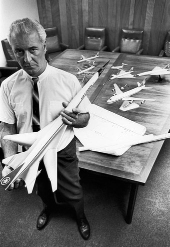 J.E. (John) Hogg of Air Canada holds a Boeing B-2707 model, with other subsonic turbine fleet types and SSTs of the period seen on the table.