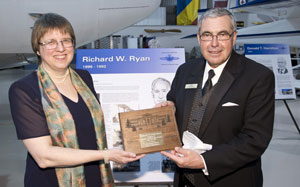 Marji Johns -- Marji Johns, left, of Brentwood Bay BC, accepted membership in the CAHF for her late grandfather, Richard Ryan. She is shown here with Bill Elliot, mayor of Wetaskiwin AB, receiving a commemorative plaque from the Alberta city. Mayor Elliot also presented Marji with a proclamation from city council declaring Richard Ryan to be an honourary citizen of Wetaskiwin, home of the Hall of Fame, located there in the Reynolds-Alberta Museum.