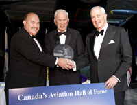 
John Timmins of Toronto, ON, centre, was one of the first four pilots hired by Hollinger Ungava Transport, a special purpose airline that operated from 1948-54 to support construction of the Quebec North Shore & Labrador Railroad. He is shown receiving a Belt of Orion Award for Excellence from Canada's Aviation Hall of Fame from board chairman John Holding, left, and Gerald Haddon, right. photography by Rick Radell. Photos courtesy Canada's Aviation Hall of Fame.