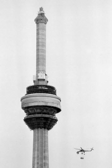 	
The Erickson S-64 Skycrane is seen lifting one of the 36 pieces of the CN Tower‘s antenna.