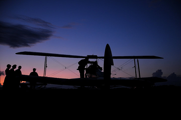 After a long day of barnstorming rides, the Edenvale Classic Aircraft Foundation’s Tiger Moth is seen silhouetted against a July evening sky. (E.D.)