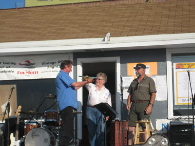  "Buffalo" Joe McBryan accepts a model of his Mk. V Norseman, CF-SAN, from Yvonne Quick, Fly-In chair, and Mike Burns of the Fox Moth Society (both are also CAHS members).