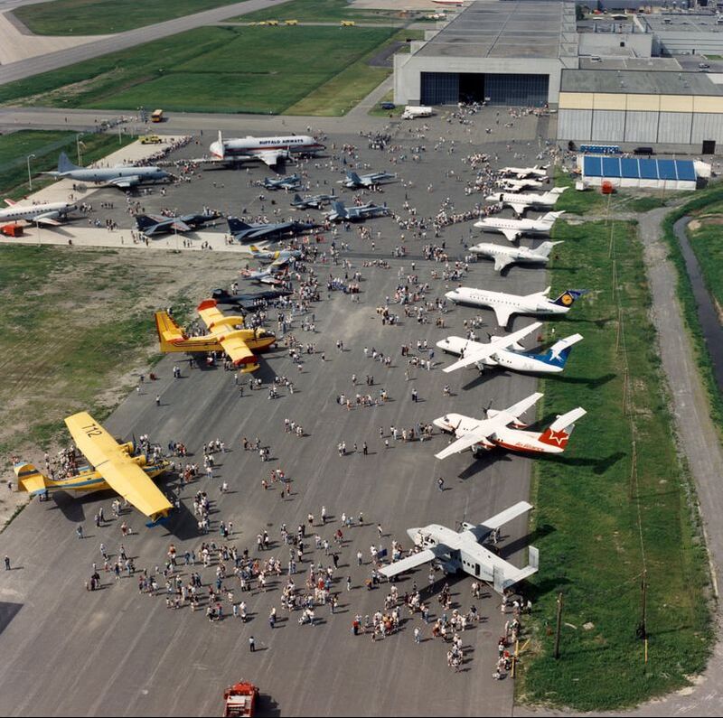 An aerial of an airshow hosted by Canadair with factory bay in the background