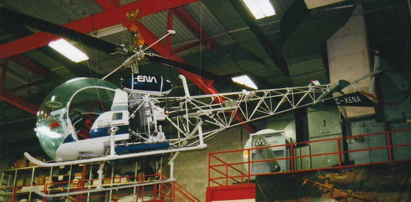Bell 47G C-XENA hangs from the ceiling at the ENA hangar.  This chopper is one of 11 helicopters in the ENA fleet.